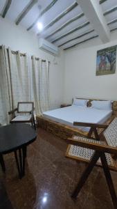 a bedroom with a bed and a table and chairs at BlackOmena 