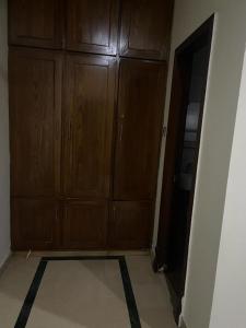 une pièce vide avec des armoires en bois et un sol dans l'établissement Warraich villa gt raod gujrat entire, à Gujrāt