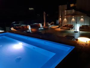 a large swimming pool in a room with chairs at Zenit Convento San Martin in Donostia-San Sebastián
