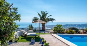a villa with a pool and a view of the ocean at B&B El Pajarero in Arenas