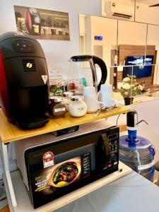 a microwave sitting on a counter in a kitchen at Dilla Homestay At Bangi UKM Kajang in Kajang