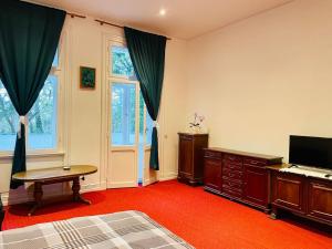 a bedroom with a bed and a desk and a television at Hamburg Billstedt Center in Hamburg