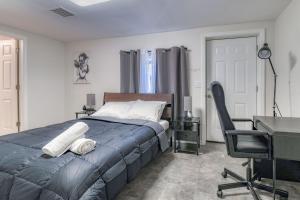 1 dormitorio con cama, escritorio y silla en Gorgeous Duplex with parking by JSQ, en Jersey City