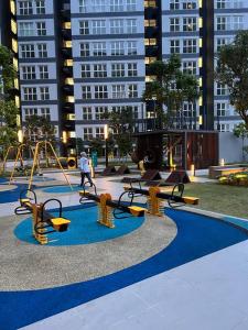 a playground with benches and swings in front of tall buildings at Dilla Homestay At Bangi UKM Kajang in Kajang +47 photos