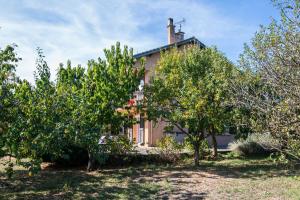 an old house with trees in front of it at Le Soleil Occitan - A 20min du Viaduc de Millau in Castelnau-Pégayrols