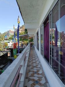 a balcony of a building with a view of a city at Wonder Hill Parivaar homestay in Darjeeling