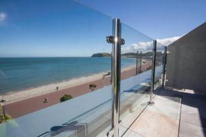 a view of the beach from the balcony of a building at St George's Hotel - Llandudno in Llandudno