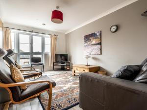 a living room with a couch and a tv at Pass the Keys Central townhouse with parking and modern finish in Exeter