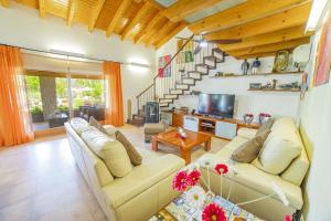 a living room with two couches and a tv at Finca Els Oscols 53 in Alcudia