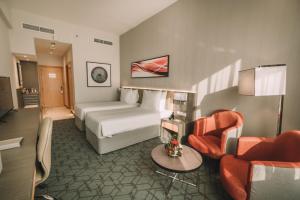 Postel nebo postele na pokoji v ubytování Peony Hotel