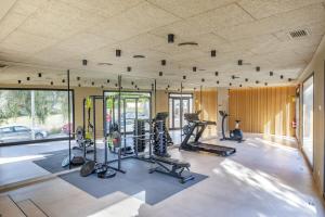 a gym with several treadmills and exercise equipment at Hotel Eden Nord Soller in Port de Soller
