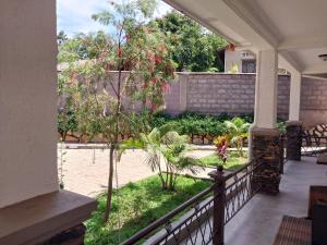 a porch with a view of a garden at Travel Sanctuary Residence - Uganda in Kampala