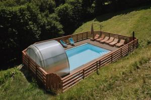 a trailer with a swimming pool in a field at Farmhouse Blackberry Pool & Wellness- Happy Rentals in Vransko