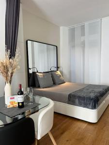 a bedroom with a bed and a table with wine glasses at Le refuge du 15 in Paris
