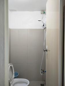 a bathroom with a toilet and a shower at Gensan Homey Apartment in General Santos