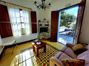 a living room with a couch and a table at Callejones in Mazo