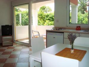 a kitchen with a table with a vase on it at Apartments Rolovina in Tivat