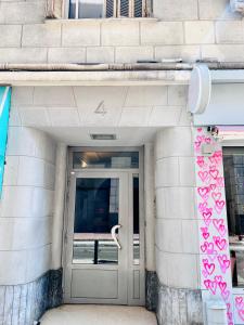 a door to a building with pink hearts on it at Congrès Résidence in Nice