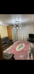 a living room with a couch and a large rug at Apartments in Chişinău