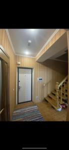 a hallway with a door and stairs in a house at Apartments in Chişinău