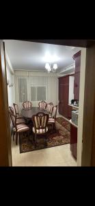 a living room with a dining room table and chairs at Apartments in Chişinău