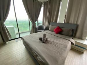 a bedroom with a bed with a pair of shoes on it at The Grand#11, Free Parking,2pax in Petaling Jaya