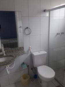 瓜拉帕里的住宿－Pousada Azul Atlântica，浴室配有白色卫生间和盥洗盆。