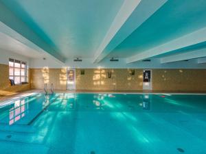 a large swimming pool in a hotel room at Hotel Jan in Szczawnica
