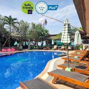 a swimming pool with lounge chairs and a hotel sign at Lanta Riviera Resort - SHA Extra Plus in Ko Lanta