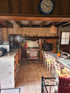 a kitchen with a large clock on the wall at LA REUNION LE LA 