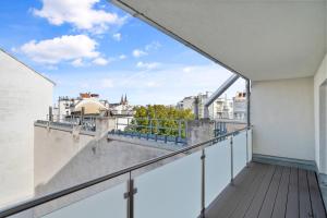an apartment balcony with a view of the city at Flora Collection in Vienna