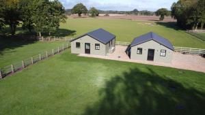 an aerial view of two houses in a field at Cabin Hideaways in Mattishall