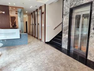 a hallway with a lobby with a staircase and a lobby at Hotel Kusum Palace in Gaya