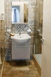 a bathroom with a sink and a shower at Casavacanzefranca - 12 in Terrasini