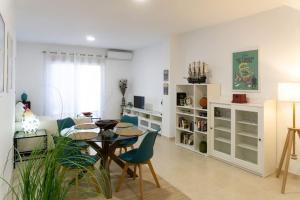 a living room with a dining room table and chairs at Estupendo apartamento en el grao in Gandía