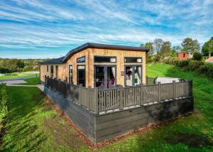 a tiny house on the side of a field at Forest Hills Lodges in Coleford