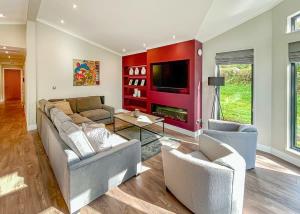 a living room with two couches and a tv at Forest Hills Lodges in Coleford