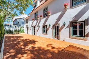 a house with a red brick driveway at Villa Azzurra Cascais 5BR in Cascais