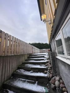 a snow covered staircase next to a building with a window at La Casita - all in one studio in Haninge in Västerhaninge