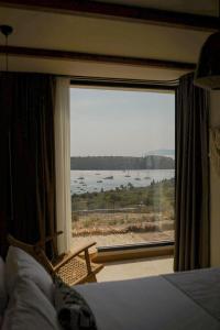 a bedroom with a large window with a view of the water at The May Five - Adults only in Seferihisar