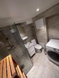 a bathroom with a shower and a toilet and a sink at La Casita - all in one studio in Haninge in Västerhaninge