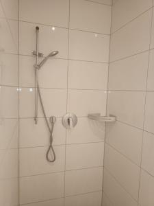 a bathroom with a shower with a shower head at L8 Street - Gneisenaustraße 9 in Pforzheim