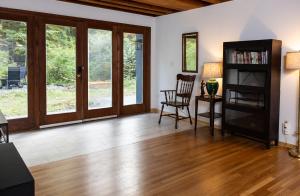 a living room with wooden floors and sliding glass doors at earthship forest exile in Temple