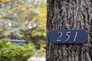 a sign on the side of a tree at earthship forest exile 