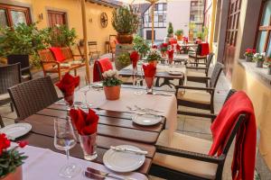 a restaurant with tables and chairs with red napkins at Laurentius Boutique-Hotel & Restaurant in Weikersheim