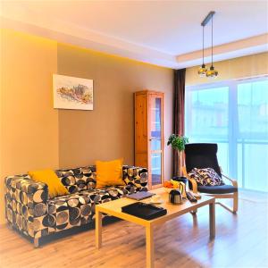a living room with a couch and a table at Apartament Garbary22 in Bydgoszcz