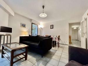 a living room with a couch and a table at Spacieux Appartement 4 Pièces, 6 Couchages, Proche Pistes et Commerces, La Salle-les-Alpes - FR-1-330F-77 in Serre Chevalier