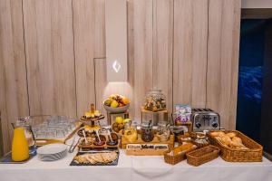 a table with a buffet of food on it at Caro Boutique Hotel in Oradea