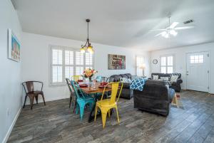 a dining room and living room with a table and chairs at WINDSTARR DESTIN- Golf Cart Included, One level, Close to beach, Pet friendly in Destin