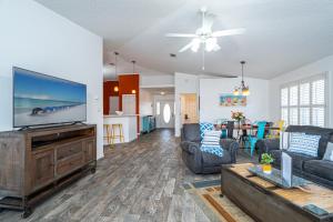 a living room with a large flat screen tv at WINDSTARR DESTIN- Golf Cart Included, One level, Close to beach, Pet friendly in Destin